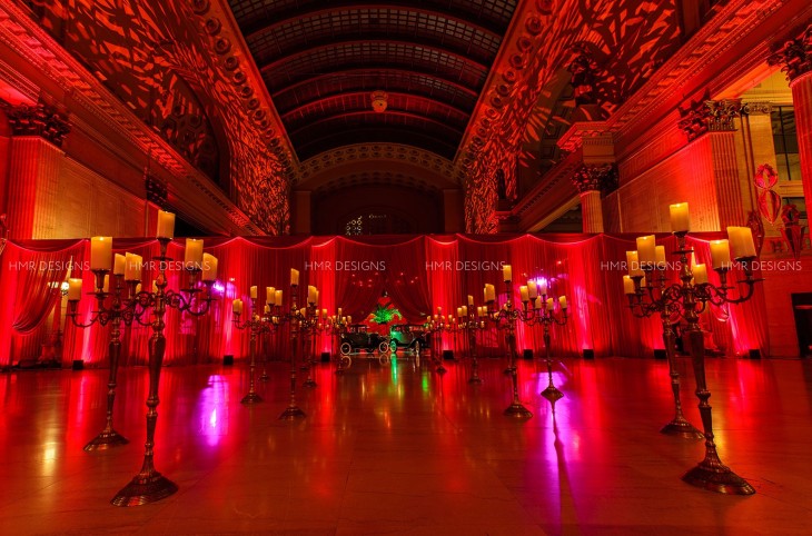 The great hall, bathed in rich crimson light by Frost Chicago. Photo by Fandl Photography.