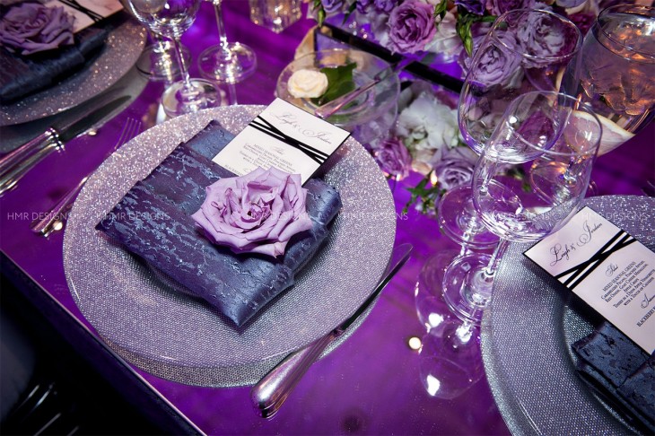 Purple roses adorn every place setting at a luxe Chicago wedding by HMR Designs